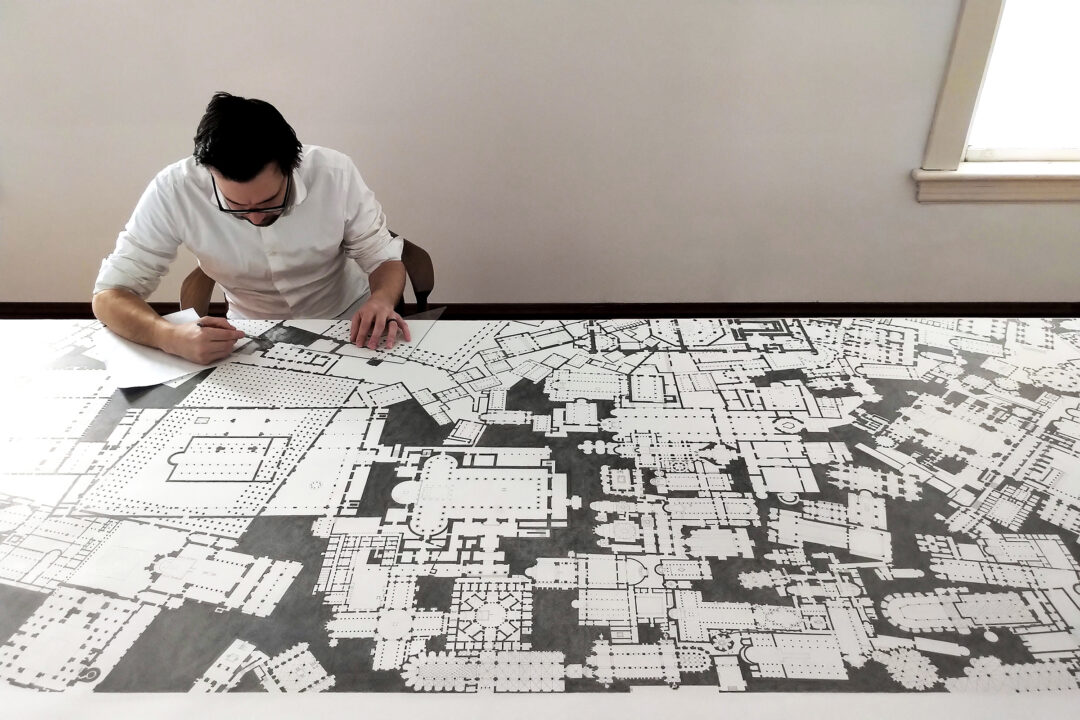 Photo of Mark Baechler drawing on a table