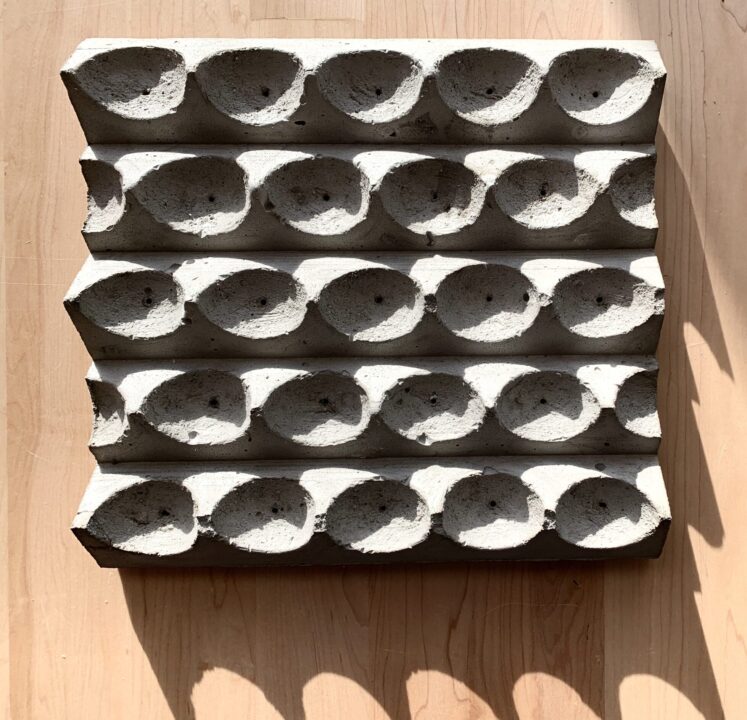 Photograph of a concrete model of multiple inverted dome casts made by a student
