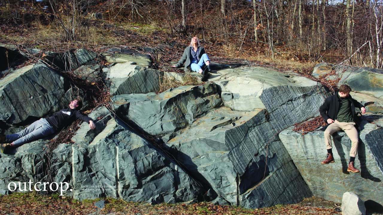 Photograph with text of students sitting on a rock outcrop