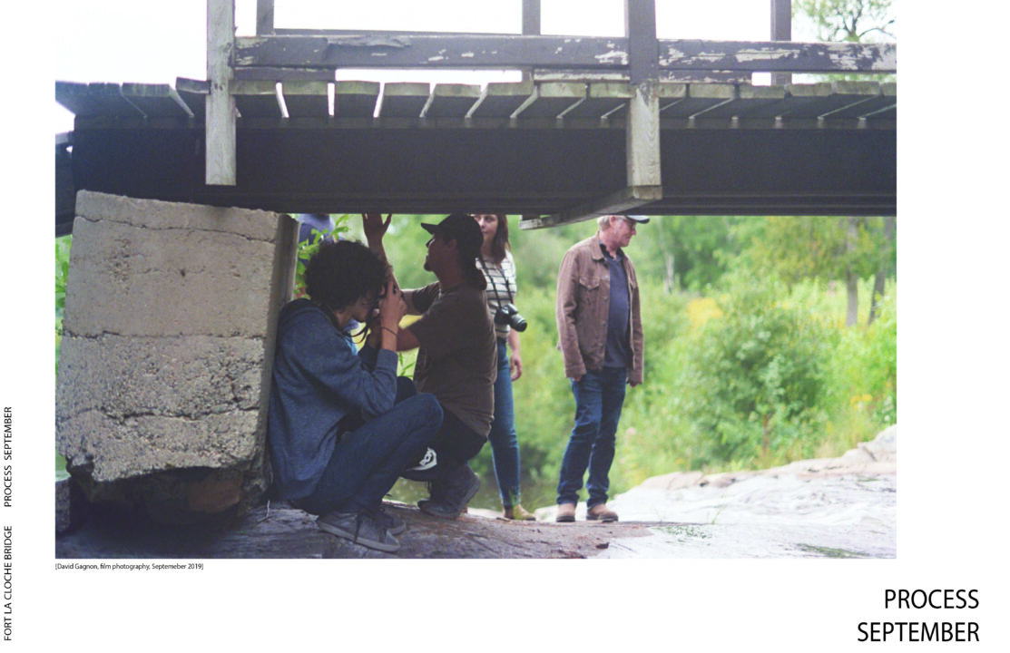 Poster with text and a photograph of students crouching under a wooden bridge in the woods
