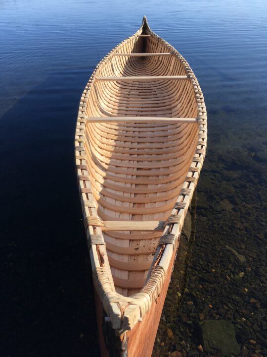 Photograph of a birch bark canoe in a body of water