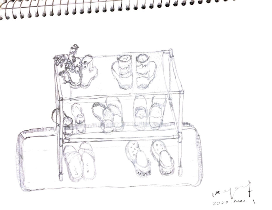Sketchbook page with a graphite perspective drawing of shoes and boots on a rack