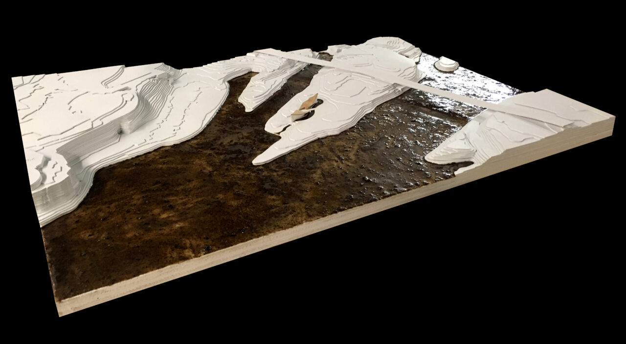 Photograph of a student made site model featuring a body of water in the center