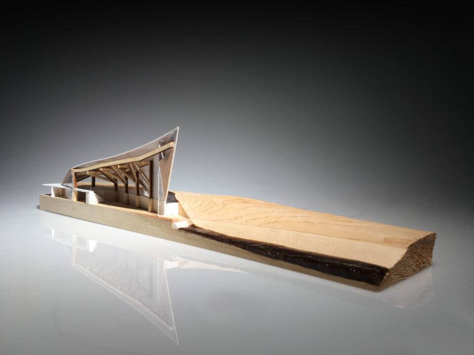 Photograph of a student made wooden model of his canoe building center