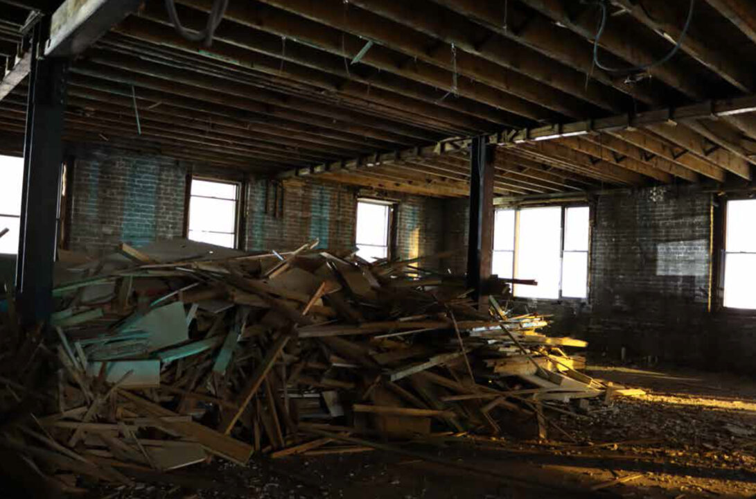 Photograph of a scrap of plywood and wood in an abandoned building