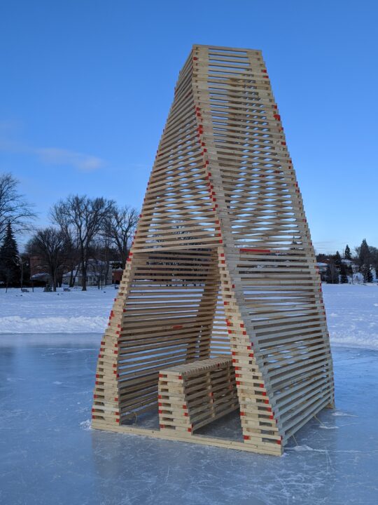 Photograph of a student made wooden ice station in the form of a cone with seating at the center