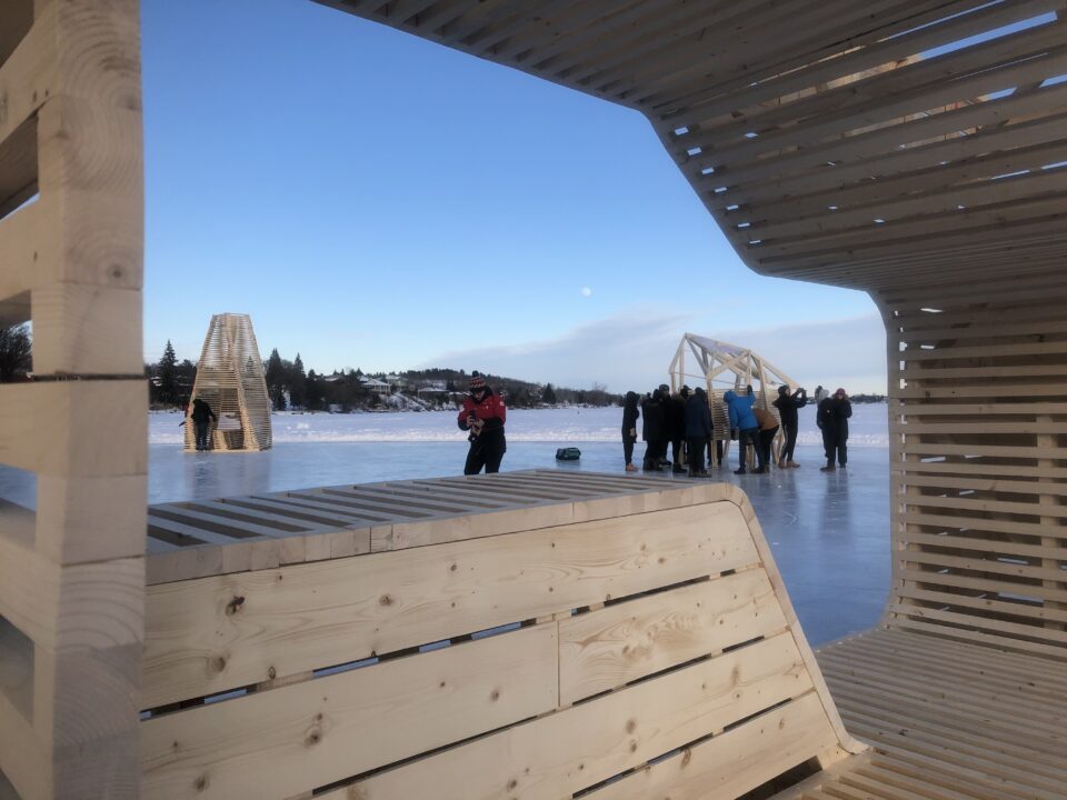 Photograph of student made wooden ice huts on a skating path in winter