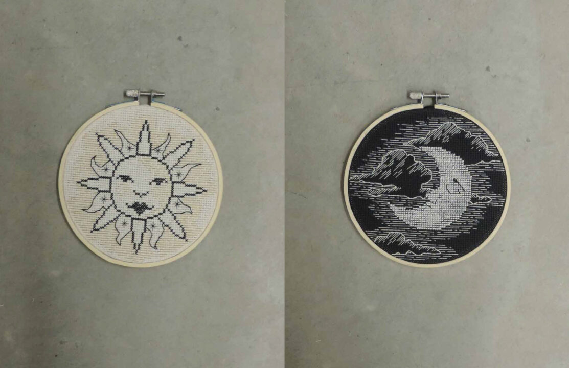 Photograph of two embroidery circles, one with a sun on a white background and the other with a moon on a black background