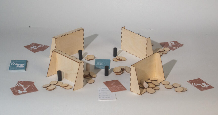 Photograph of a four wooden sets of game pieces and tokens for a game