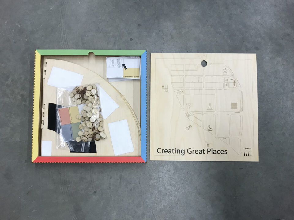 Photograph of a wooden board game designed by students, in a box