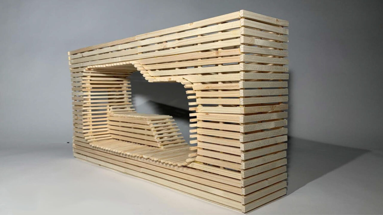 Photograph of a wooden wall shaped model with a lounge chair cut out in the center