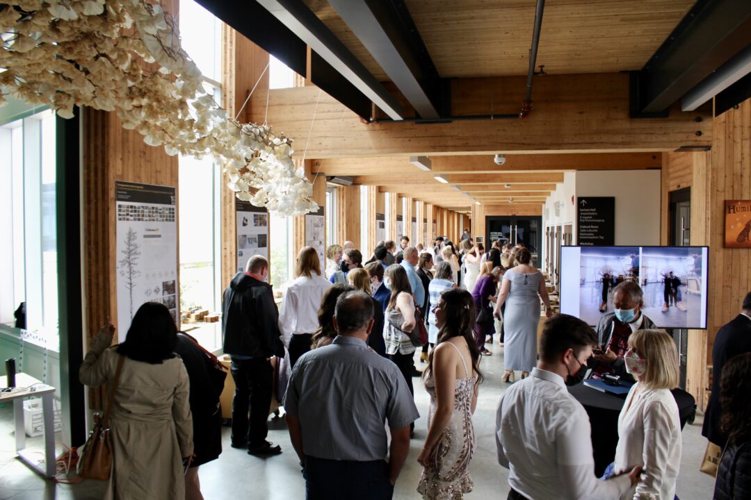 photo of a crowd looking at the exhibition of student work