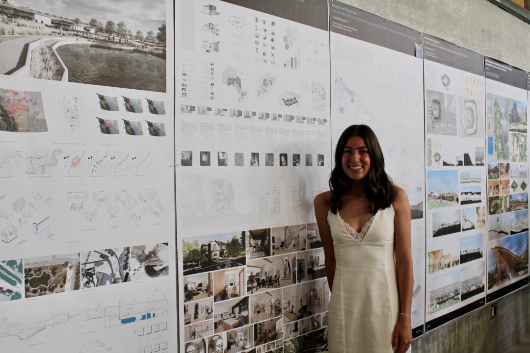 Photo of student showing their thesis work
